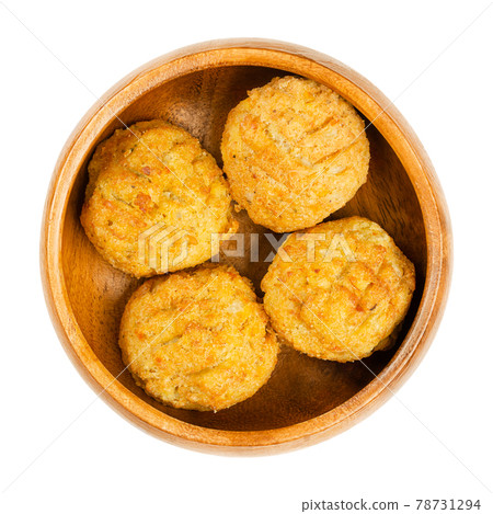 Pre-fried vegan falafel balls, in a wooden bowl. Group of ball shaped fritters, based on chickpeas and rice, a traditional Middle Eastern food. Convenience food. Close-up from above, macro food photo. 78731294