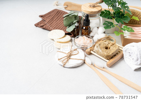 Natural bathroom and home spa tools. Zero waste sustainable lifestyle concept. Bamboo toothbrush, natural shampoo, cotton pads, homemade DIY beauty products in reusable bottles on white background 78731547