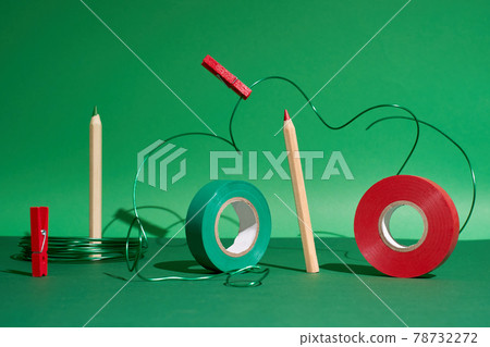 Creative art set pencils, red and green tape, pins, green wire on green back 78732272