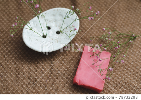Natural handmade soap bar with ceramic soap dish and flowers, spa organic soap, sustainable lifestyle Natural handmade soap bar with ceramic soap dish and flowers, spa organic soap, sustainable lifestyle 78732298