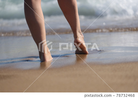 Woman goes to sea, part of body enjoying time on beach Woman goes to sea, part of body enjoying time on beach 78732468
