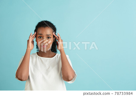 Half-length portrait of young beautiful girl in casual clothes isolated on light blue background. Half-length portrait of young beautiful girl in casual clothes isolated on light blue background. 78733984