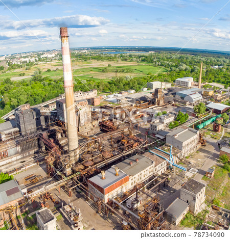 Aerial drone shot of old industrial zone with smoke stack. Air pollution concept Aerial drone shot of old industrial zone with smoke stack. Air pollution concept 78734090