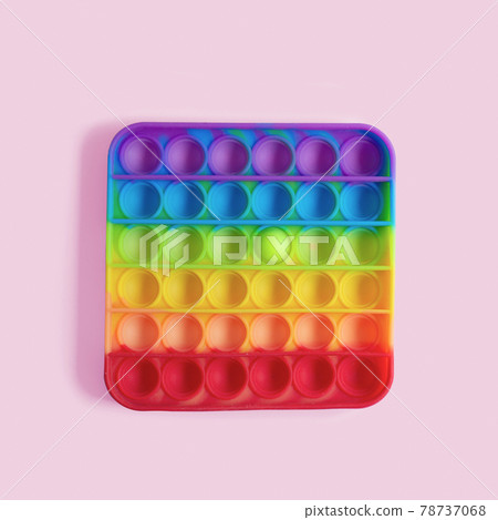 Rainbow pop it, fidget toy, with single circle popped; Creative minimal concept of being different, stand out 78737068