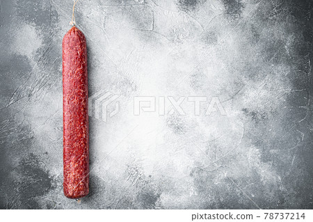 Fresh baked sausage Salami, on gray stone table background, top view flat lay, with copy space for text Fresh baked sausage Salami, on gray stone table background, top view flat lay, with copy space for text 78737214