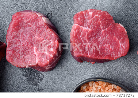 Prime Raw Fillet Mignon tenderloin steaks, on gray stone background, top view flat lay Prime Raw Fillet Mignon tenderloin steaks, on gray stone background, top view flat lay 78737272