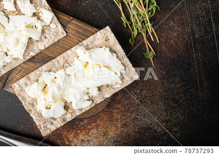 Crispbreads with feta, on old dark rustic table background, top view flat lay, with copy space for text Crispbreads with feta, on old dark rustic table background, top view flat lay, with copy space for text 78737293