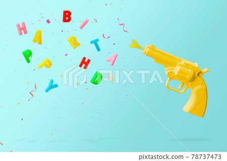 Yellow pistol shooting colorful birthday candles and colorful confetti, against blue background. Happy birthday concept with copy space Yellow pistol shooting colorful birthday candles and colorful confetti, against blue background. Happy birthday concept with copy space 78737473