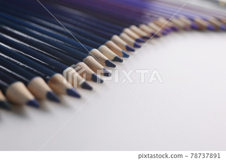 Many shades of wooden blue pencils lying on white background closeup 78737891