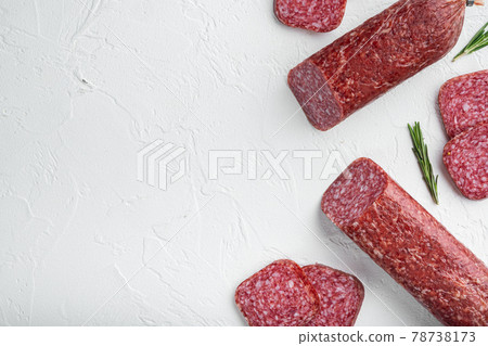 Salami with fresh rosemary and spices, on white stone table background, top view flat lay, with copy space for text Salami with fresh rosemary and spices, on white stone table background, top view flat lay, with copy space for text 78738173
