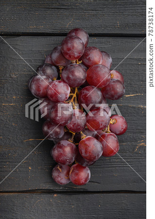 Natural organic juicy grapes, dark red fruits, on black wooden table , top view flat lay Natural organic juicy grapes, dark red fruits, on black wooden table , top view flat lay 78738174
