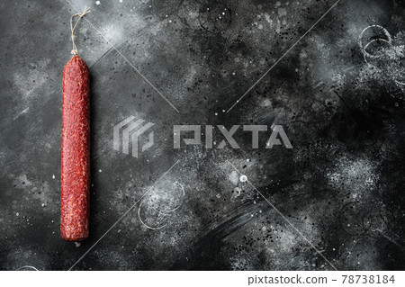 Salami sausage, on black dark stone background, top view flat lay, with copy space for text Salami sausage, on black dark stone background, top view flat lay, with copy space for text 78738184