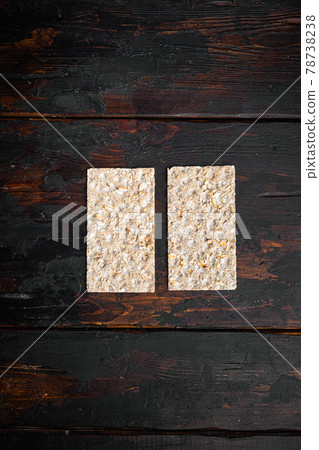 Crispbread with sunflower, chia and sesames seeds, on old dark wooden table background, top view flat lay, with copy space for text Crispbread with sunflower, chia and sesames seeds, on old dark wooden table background, top view flat lay, with copy space for text 78738238