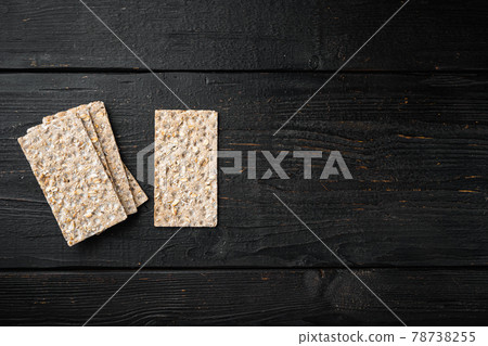 Crisp bread with sunflower, chia and sesames seeds, on black wooden table background, top view flat lay, with copy space for text Crisp bread with sunflower, chia and sesames seeds, on black wooden table background, top view flat lay, with copy space for text 78738255