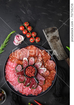 Spanish cold meat plate, chorizo, fuet, lomo,longaniza and salchichon on balck background, top view Spanish cold meat plate, chorizo, fuet, lomo,longaniza and salchichon on balck background, top view 78738256