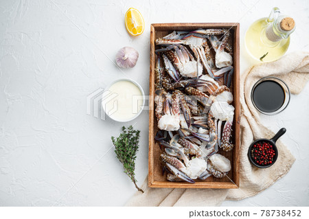 Fresh blue swimming crab parts, in wooden box, on white background, top view flat lay , with copyspace and space for text Fresh blue swimming crab parts, in wooden box, on white background, top view flat lay , with copyspace and space for text 78738452