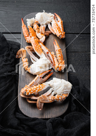 Boiled blue swimming crab parts, on black wooden table background Boiled blue swimming crab parts, on black wooden table background 78738454
