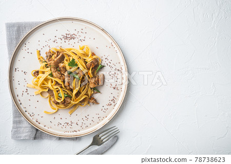 Rabbit stew tagliatelle, on plate, on white stone background, top view flat lay, with copy space for text Rabbit stew tagliatelle, on plate, on white stone background, top view flat lay, with copy space for text 78738623