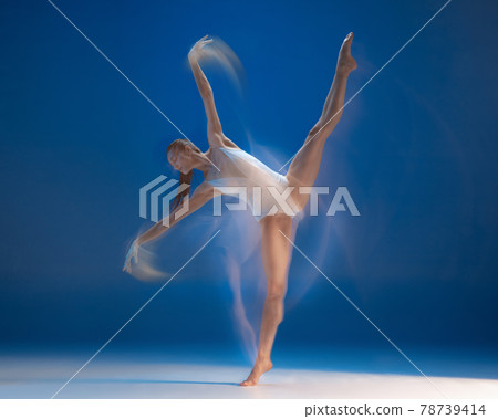 Graceful young beautiful girl, female ballet dancer dancing isolated over blue background. Reflection effect Graceful young beautiful girl, female ballet dancer dancing isolated over blue background. Reflection effect 78739414