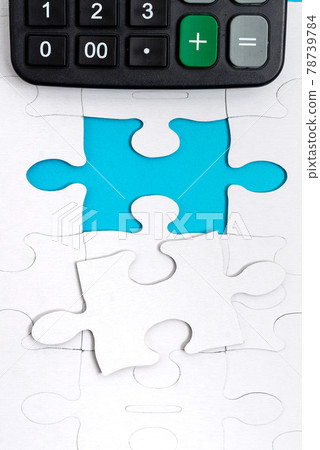 Close-Up White Jigsaw Pattern Puzzle Pieces To Be Connected With Missing Last Piece Positioned On A Flat Lay Background With Different Texture And Paper Supplies Accesories Close-Up White Jigsaw Pattern Puzzle Pieces To Be Connected With Missing Last Piece Positioned On A Flat Lay Background With Different Texture And Paper Supplies Accesories 78739784