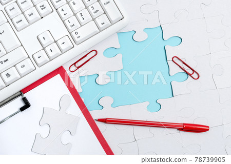 Close-Up White Jigsaw Pattern Puzzle Pieces To Be Connected With Missing Last Piece Positioned On A Flat Lay Background With Different Texture And Paper Supplies Accesories Close-Up White Jigsaw Pattern Puzzle Pieces To Be Connected With Missing Last Piece Positioned On A Flat Lay Background With Different Texture And Paper Supplies Accesories 78739905