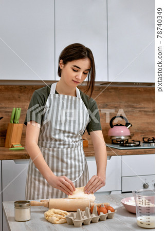 Young beautiful housewife cooking on kitchen at home. 78740349