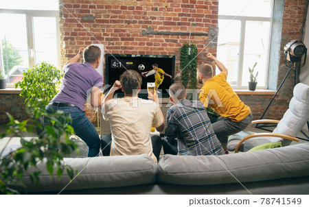 Group of friends watching TV, sport match together. Concept of friendship, leisure activity, emotions Group of friends watching TV, sport match together. Concept of friendship, leisure activity, emotions 78741549