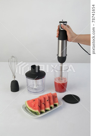whisking watermelon in a bowl with immersion hand blender. whisking watermelon in a bowl with immersion hand blender. 78741654