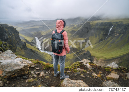 Close up of a woman with backpack enjoying icelandic highland and river fossa close to Haifoss waterfall in Iceland 78742487