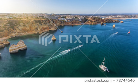 Aerial view of the beautiful paradise beaches of Camilo and Dona Anna, Lagos area. Tourist boats and ships entertain tourists on summer vacations. 78744540