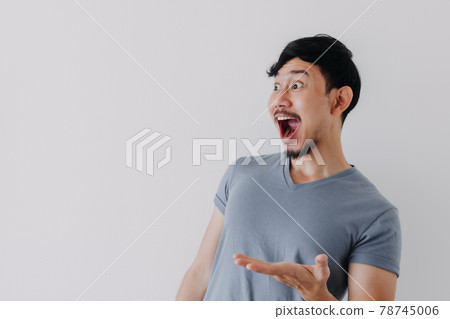 Shocked and surprised face of man in blue t-shirt isolated on white background. Shocked and surprised face of man in blue t-shirt isolated on white background. 78745006