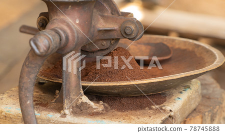 Roasting coffee beans by using traditional local coffee roast maker machine in local traditional industry factory. 78745888
