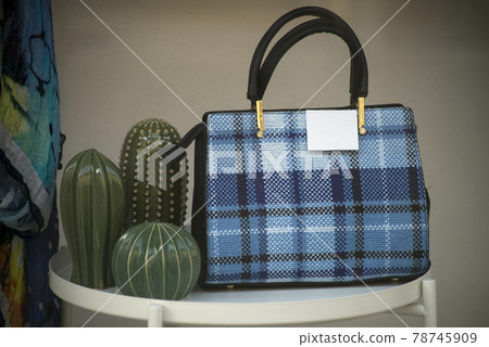 Closeup of blue handbag in a fashion store showroom Closeup of blue handbag in a fashion store showroom 78745909