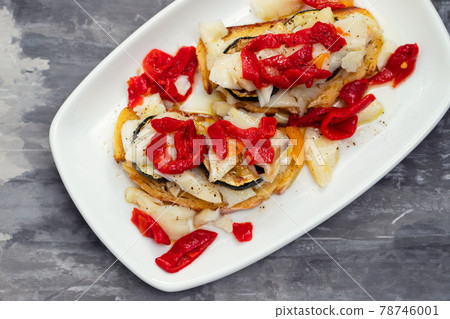 corn bread with cod fish and courgette on white dish 78746001