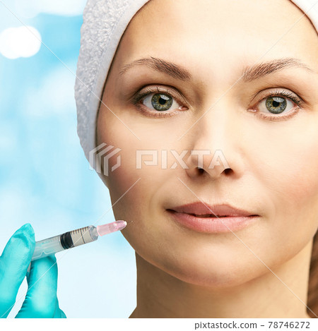 Woman face cosmetology treatment. Biorevitalization skin therapy. Doctor insert Woman face cosmetology treatment. Biorevitalization skin therapy. Doctor insert 78746272