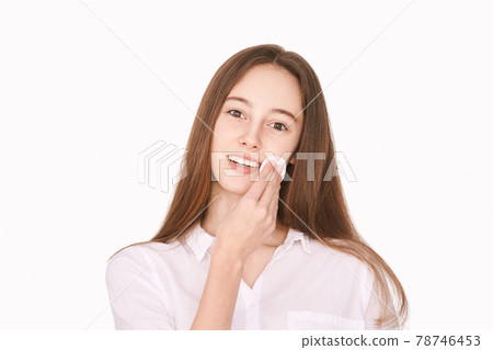 Female teenager person. Cleansing dirty skin. Remove mascara. Cotton pad face 78746453