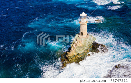 The beautiful Lighthouse Tourlitis of Chora at night. Andros island, Cyclades, Greece The beautiful Lighthouse Tourlitis of Chora at night. Andros island, Cyclades, Greece 78747211