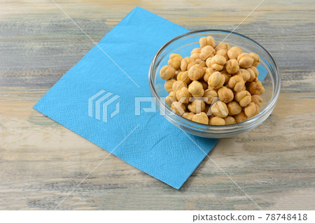 Turkish salted roasted chickpeas in glass snack bowl with blue napkin on table 78748418