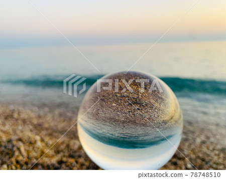 close up crystal glass ball at the beach. close up crystal glass ball at the beach. 78748510