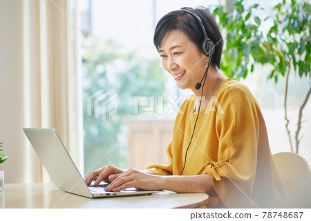 Middle woman having an online meeting in the living room 78748687