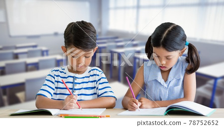 Composition of schoolboy and schoolgirl sitting beside each other working in class Composition of schoolboy and schoolgirl sitting beside each other working in class 78752652