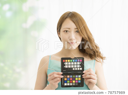 A woman with a color chart A woman with a color chart 78757989