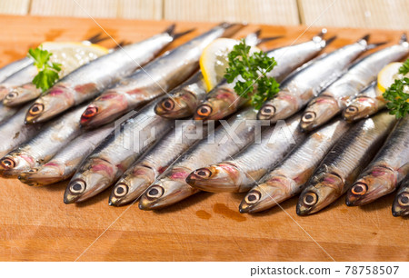 Pickled European anchovies with lemon and greens Pickled European anchovies with lemon and greens 78758507
