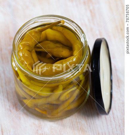 Glass jar with pickled green hot pepper Glass jar with pickled green hot pepper 78758705