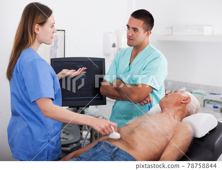 man doctor and female nurse examines elderly man man doctor and female nurse examines elderly man 78758844