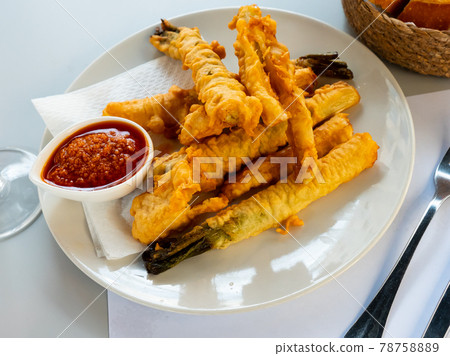 Tempura fried calcots served with Romesco sauce Tempura fried calcots served with Romesco sauce 78758889