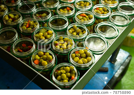 Glass cans filled with marinated olives Glass cans filled with marinated olives 78758890