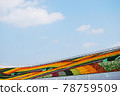 Decorated outdoor bleacher with colorful flowers. 78759509