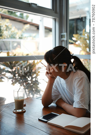 Portrait of peaceful young woman looking through the window. Portrait of peaceful young woman looking through the window. 78760902