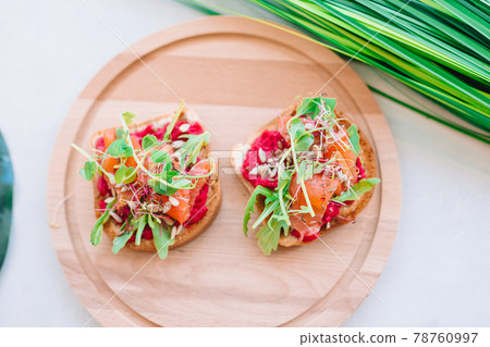 Tasty italian bruschetta on the wooden plate Tasty italian bruschetta on the wooden plate 78760997